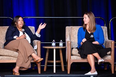 Raynce Rouce, MD (left) talks with Clare Pierce-Wrobel